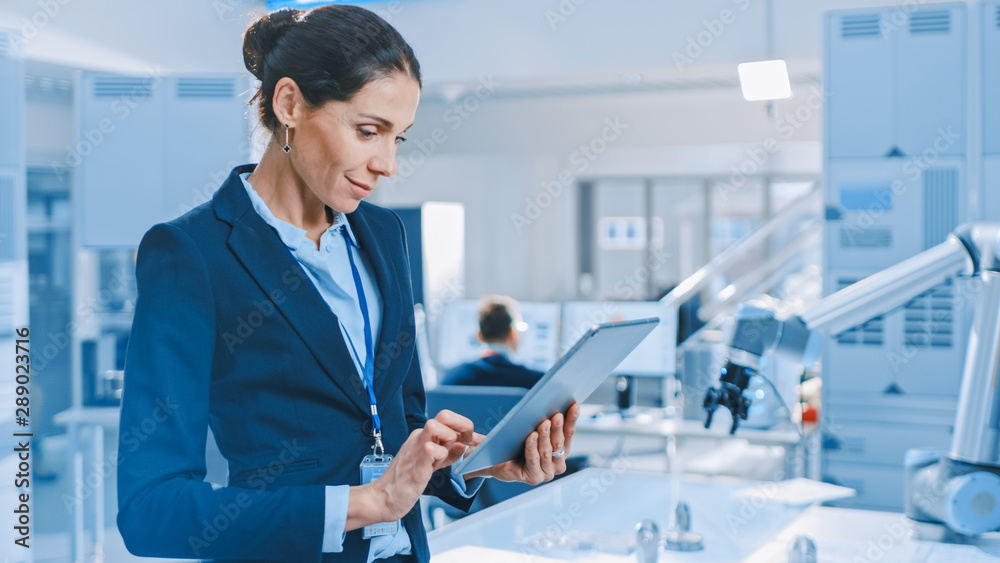 Aufkleber Stylish Female Industrial Robotics Engineer Uses Tablet Computer to Program and Manipulate Robot Arm for Lifting, Moving Objects. Technology Research Facility for Machine Learning and Cloud Computing