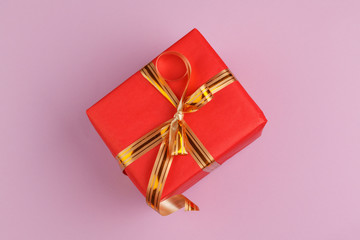beautiful gift box wrapped in holiday paper with bow, top view