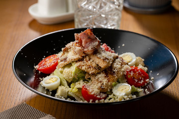Warm salad with lettuce, eggs and meat, food close-up