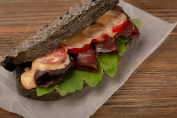 Sandwich with red meat and sauce, food close-up