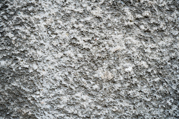 Texture of an old cracked concrete wall. Background image of a worn gray concrete surface