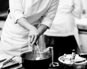 chef preparing food, chef cooking in a kitchen, chef at work, Black and White