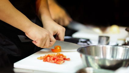 Obraz na płótnie Canvas Chef preparing food in the kitchen, chef cooking, Chef decorating dish