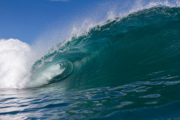 dramatic beach scene of a huge crashing wave