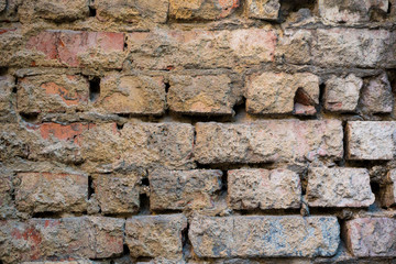 Texture of an old paint covered brick wall. Background image of an abandoned brick wall with painted over paint