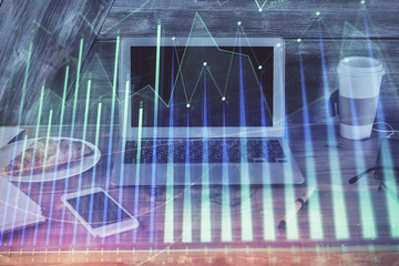 Financial graph colorful drawing and table with computer on background. Double exposure. Concept of international markets.