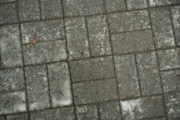 Texture of paving slabs overgrown with grass. Background image of a stratum stone