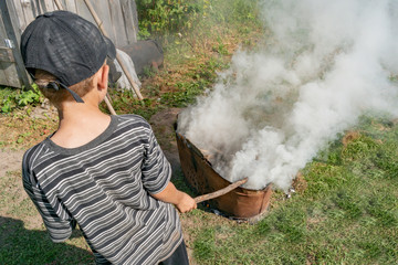 Little boy playing with smoke and fire