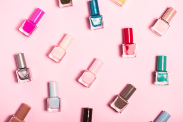 Colorful Nail polish bottles pattern background. Close up.