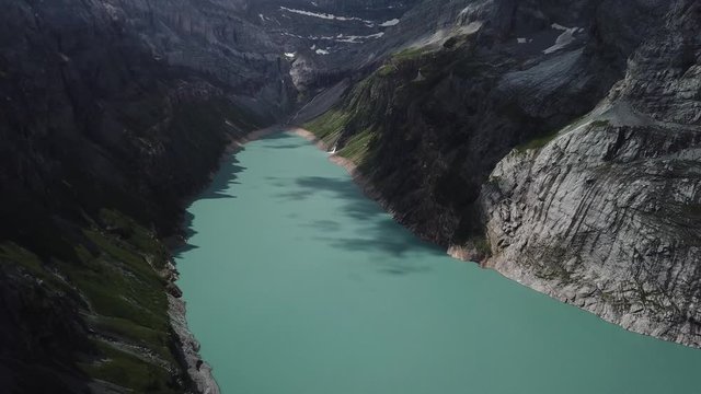 Linth&ndash;Limmern Power Station, dam in Linthal, Glarus, Switzerland Aerial drone dolly out shot over the beautiful blue lake