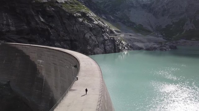 Linth–Limmern Power Station, man walking on the dam in Linthal, Glarus, Switzerland