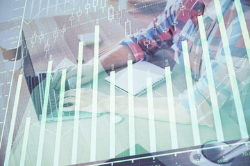 Multi exposure of forex graph with man working on computer on background. Concept of market analysis.