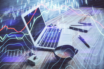 Double exposure of chart and financial info and work space with computer background. Concept of international online trading.