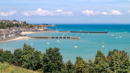 Panoramic view of Cancale in summer day: the city, the beach, ocean with yachts and boats. Brittany region of France.