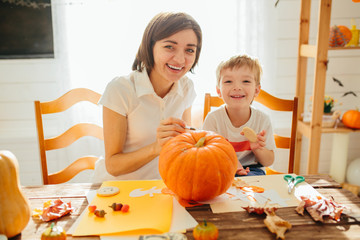 family of mother and children decorate the home for Halloween Happy Halloween concept