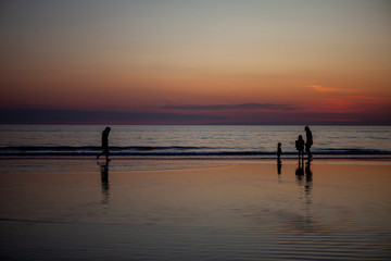 family silhouette on the beach