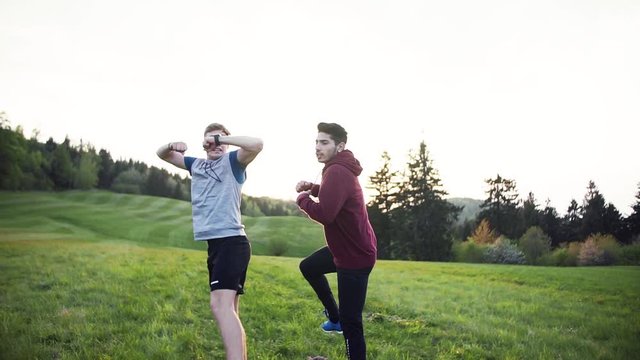 A Rear View Of Young Men Walking After Exercise In Nature. Slow Motion.