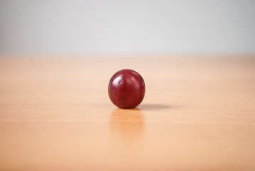 A fruit of red  grape on wooden table