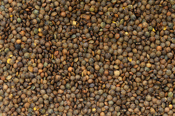 Top view macro image of brown lentils as a natural healthy food background.