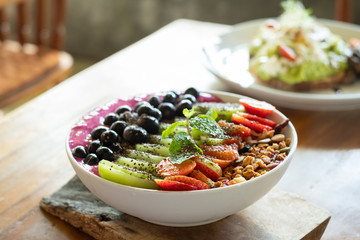 Breakfast bowl, yogurt, fruit and muesli, healthy, health food, strawberries, kiwi fruit, blackberries, side view
