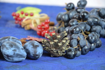 Autumn harvest, grapes, autumn fallen leaves, apples, plums, cinnamon, anise. wild grapes in autumn in the rain