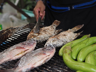Street food in thailand grilling fish