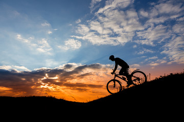 Cyclist man silhouette and mountain bike.