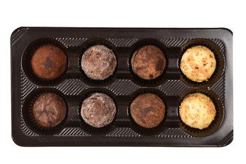 Chocolate candy collection in plastic box.