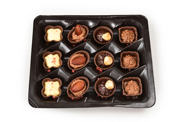 Chocolate candy collection in plastic box.