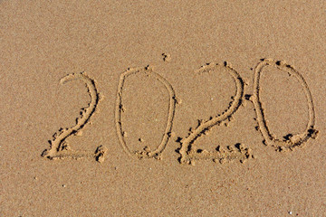 New year 2020. Inscription on a sandy beach. Tropical celebration concept