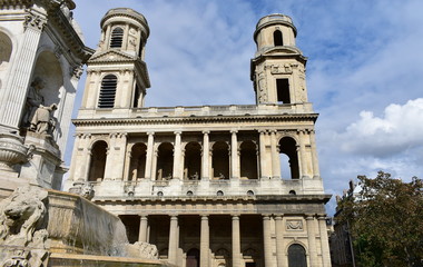 Fototapeta na wymiar Church of Saint Sulpice neoclassical facade with fountain. Paris, France.
