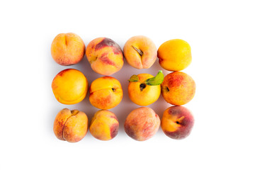Fresh peaches and nectarines isolated over white background, top view. Clipping path at 400%