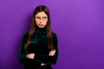 Portrait of sad beautiful millennial looking crossing her hands wearing eyeglasses eyewear isolated over purple violet background