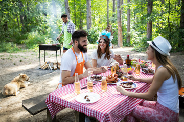 Group of friends having a barbecue party in nature