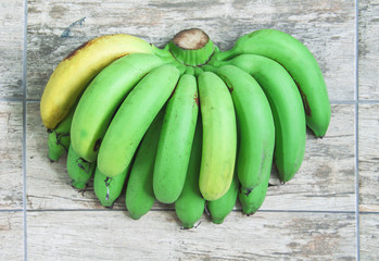 Fresh organic green and yellow bananas fruit group ( Gros Michel  ) on wood table background top...
