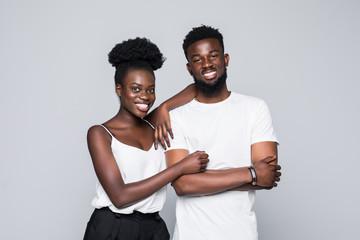 Young happy african couple standing isolated on gray background