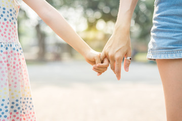 Close up Daughter hand holding with her Mother , feel comforted  and affectionate, happy family time