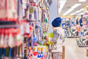 boy chooses pens for school. the child in the store selects the goods.
