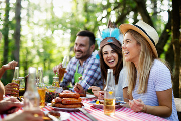Happy friends enjoying barbecue and grill party outdoor