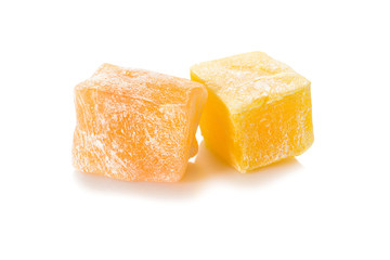 Turkish delight. Honey rahat locum, two pieces of of sweet oriental delights in powered sugar. Close-up view.