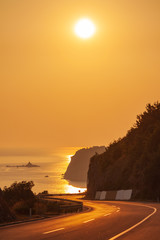 orange sunset over the road to the sea