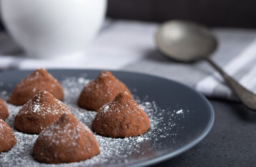 chocolate truffles on a wooden plate