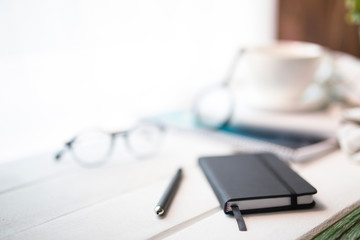 workplace with a notebook and a cup of coffee