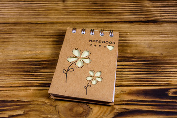 Closed small notepad on a wooden table