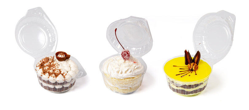 Group of desserts in plastic containers isolated on white background