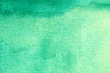 mint watercolors on textured paper surface
