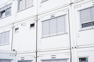 Containers officers in white color with gray windows, temporary workspace for supporting workers in a construction environment.