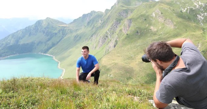 Photographer taking pictures of a model in the swiss alps near Lake Ritom.