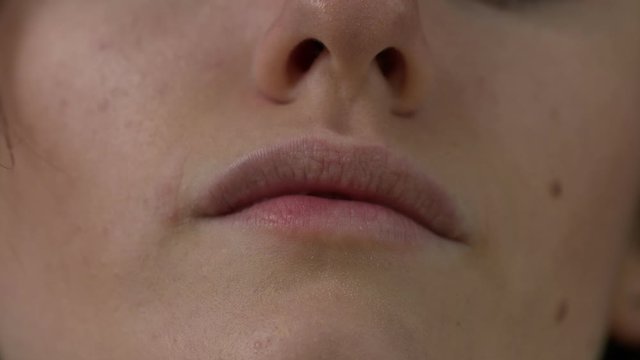 Closeup shot of a womans mouth and nose, completely natural without makeup.