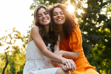 Fototapeta premium Two cheerful young girls friends spending time outdoors